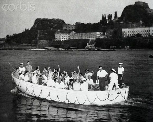 26 Aug 1954, Corfu Island, Greece --- Waving like a bunch of delighted tourists, a boat load of European royalty heads for the Greek Island of Corfu, the first stop on the cruise of kings. King Paul of Greece and his Queen Frederika invited some hundred-odd members of Europe's royal families to tour the Aegean sea aboard the Greek liner Agamemnon. After visiting Corfu the Agamemnon heads for Olympia. While at Corfu, Queen Frederika made sure that the royal guests wouldn't go hungry. She ordered 100 lobsters, 10 lambs and 15 suckling pigs taken aboard. --- Image by © Bettmann/Corbis